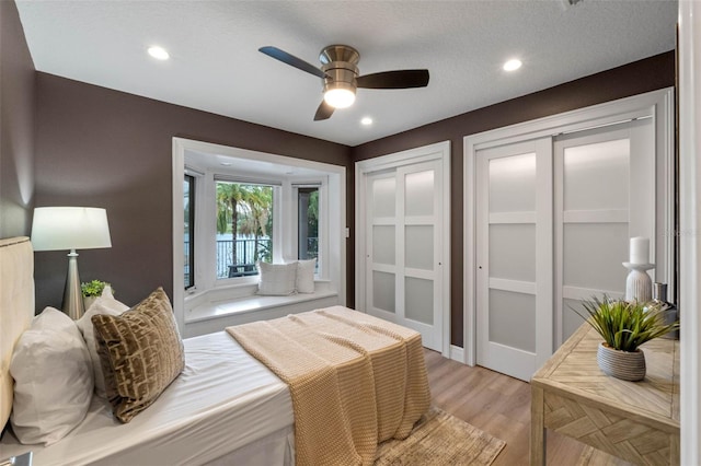 1105 Lake Nettie Dr, Eustis, FL 32726 - bedroom with light wood-type flooring, two closets, recessed lighting, and a ceiling fan