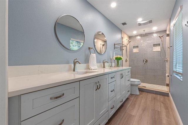 1105 Lake Nettie Dr, Eustis, FL 32726 - full bath featuring wood finished floors, double vanity, tiled shower, plenty of natural light, and recessed lighting