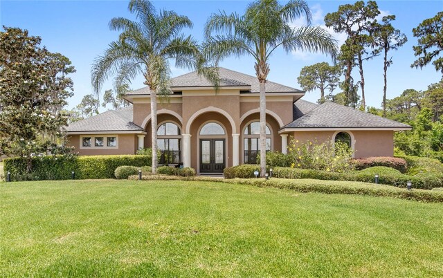 view of front of property with french doors, a front yard, and stucco siding