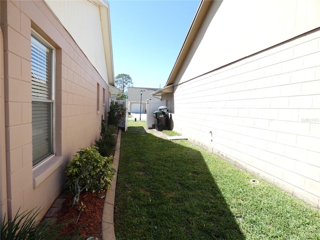 9313 Pavillion Dr, Orlando, FL 32825 - view of side of property with a yard and concrete block siding