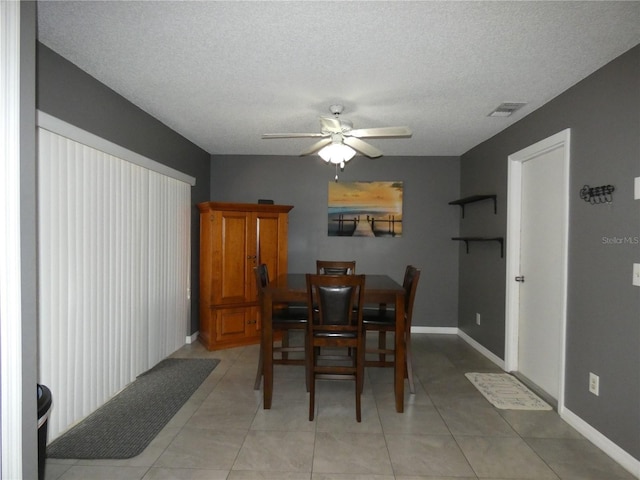 9313 Pavillion Dr, Orlando, FL 32825 - dining space featuring a textured ceiling, baseboards, visible vents, ceiling fan, and light tile patterned floors