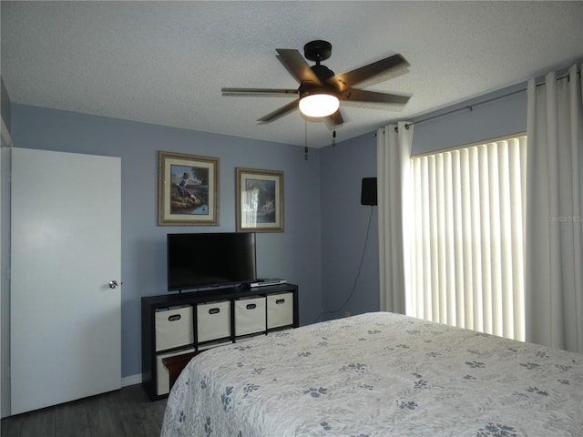 9313 Pavillion Dr, Orlando, FL 32825 - bedroom with baseboards, a textured ceiling, dark wood-type flooring, and ceiling fan