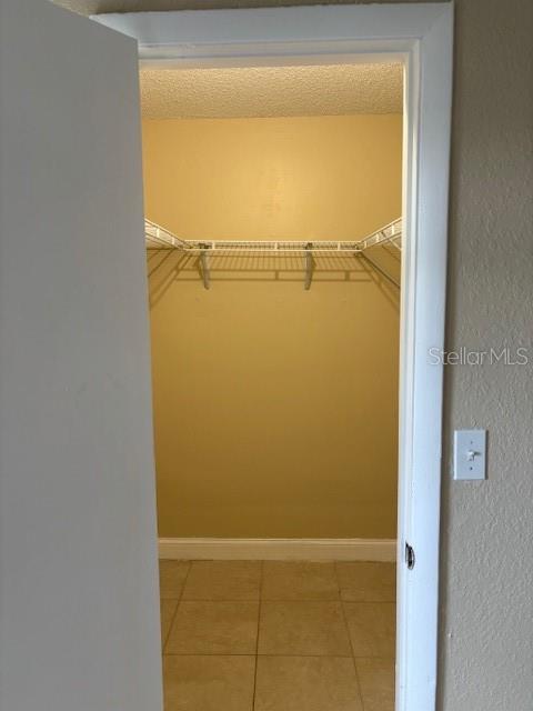 walk in closet featuring light tile patterned floors