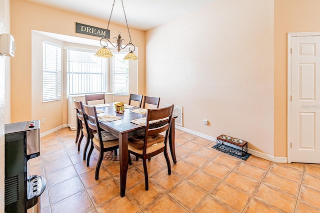 dining space with baseboards and light tile patterned flooring