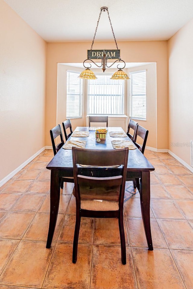 dining room with visible vents, baseboards, a chandelier, and light tile patterned floors