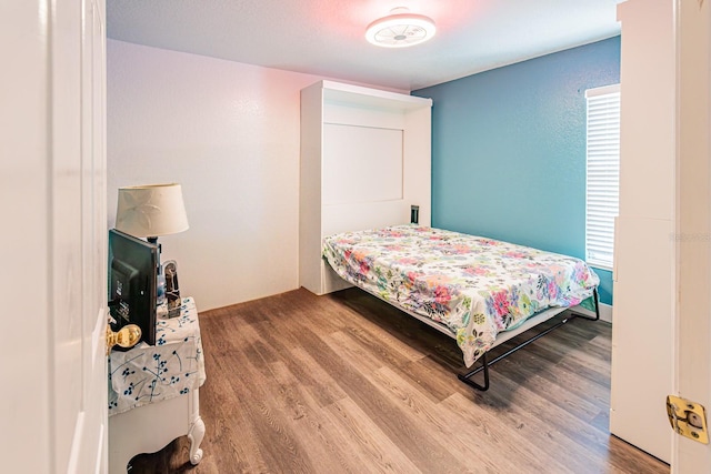 bedroom with wood finished floors