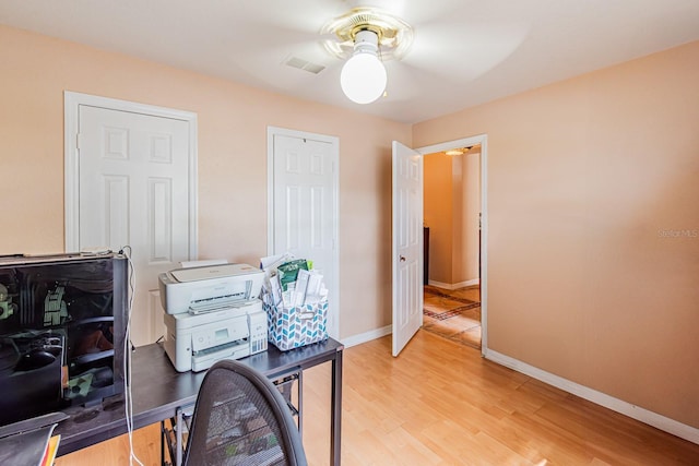 office with ceiling fan, baseboards, light wood-style floors, and visible vents