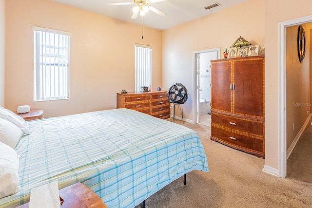 bedroom featuring visible vents, a ceiling fan, light carpet, baseboards, and ensuite bathroom