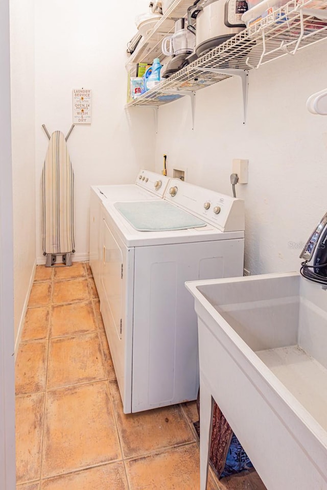 laundry room with washing machine and dryer, a sink, laundry area, and light tile patterned flooring