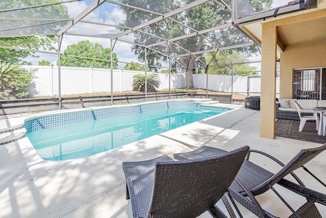 view of pool featuring glass enclosure, a fenced in pool, a patio, and a fenced backyard