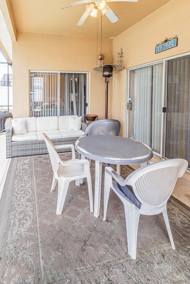 view of patio / terrace with a ceiling fan and an outdoor living space