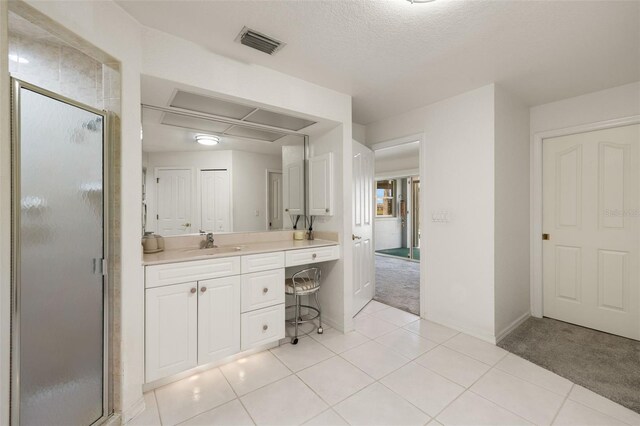 9277 St Paul Dr, Port Charlotte, FL 33981 - full bathroom featuring a shower stall, vanity, baseboards, tile patterned flooring, and a textured ceiling
