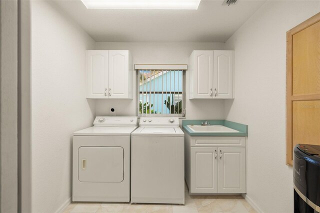 9277 St Paul Dr, Port Charlotte, FL 33981 - laundry room featuring washer and clothes dryer, cabinet space, and baseboards