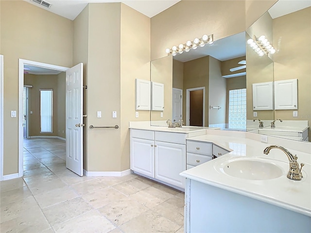 3020 Zaharias Dr, Orlando, FL 32837 - bathroom with baseboards, a sink, and two vanities