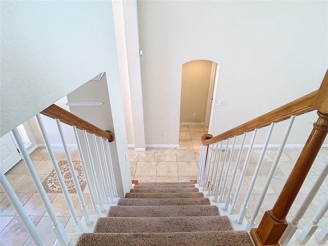 3020 Zaharias Dr, Orlando, FL 32837 - stairs with baseboards, arched walkways, and tile patterned floors