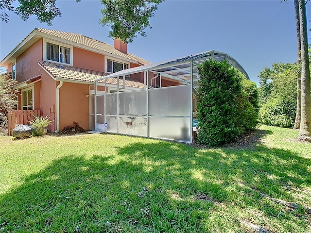 3020 Zaharias Dr, Orlando, FL 32837 - rear view of property featuring a yard, a tiled roof, a lanai, and stucco siding