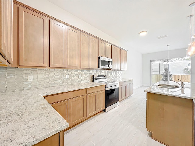kitchen featuring stainless steel appliances, a sink, visible vents, decorative backsplash, and light stone counters