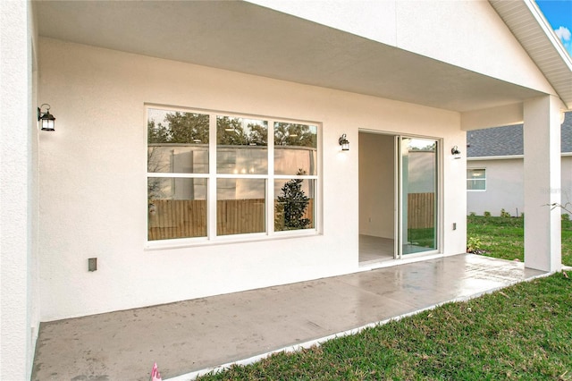 exterior space with a patio and stucco siding