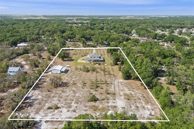 aerial view featuring a wooded view