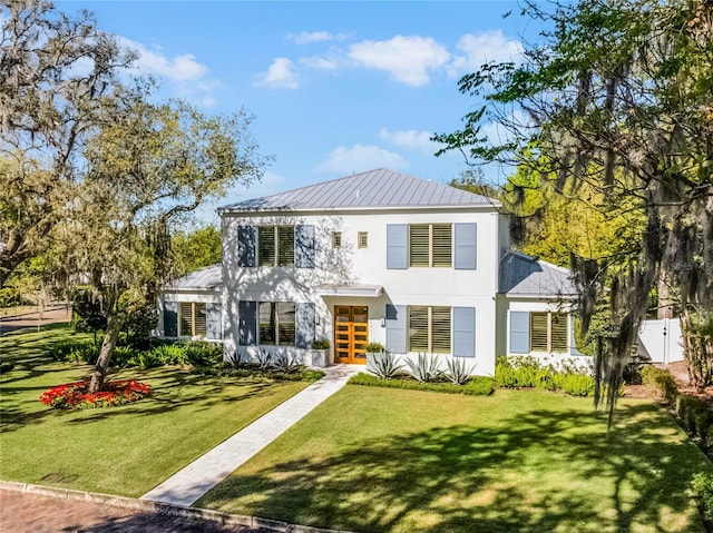 2171 Forrest Rd, Winter Park, FL 32789 - view of front of property featuring stucco siding, metal roof, a front yard, and a standing seam roof