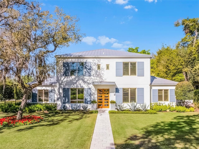 2171 Forrest Rd, Winter Park, FL 32789 - view of front of property with stucco siding, french doors, a front yard, and metal roof