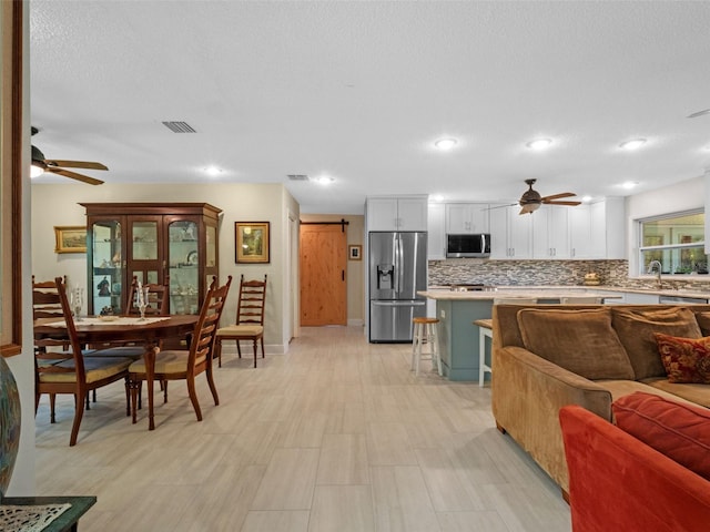 1139 Fairway Dr, Winter Park, FL 32792 - kitchen with appliances with stainless steel finishes, ceiling fan, open floor plan, light countertops, and recessed lighting