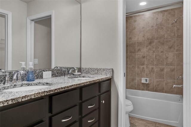 8814 Geneve Ct, Kissimmee, FL 34747 - full bathroom with washtub / shower combination, a sink, double vanity, and toilet