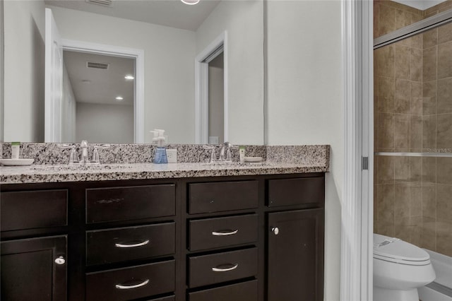 8814 Geneve Ct, Kissimmee, FL 34747 - bathroom featuring visible vents, toilet, tiled shower, and a sink