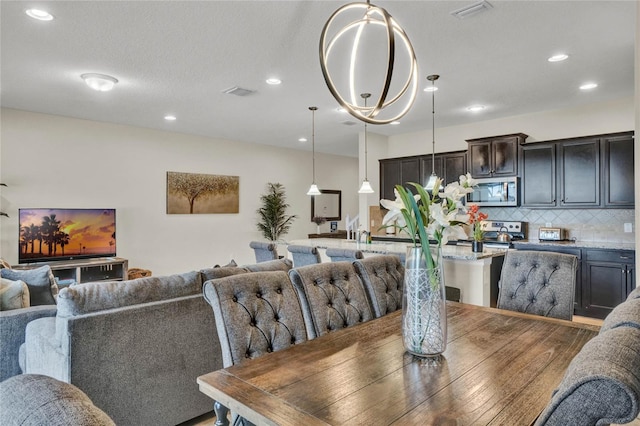 8814 Geneve Ct, Kissimmee, FL 34747 - dining room featuring visible vents and recessed lighting