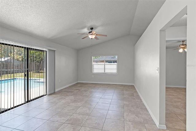 spare room featuring light tile patterned flooring, ceiling fan, and a healthy amount of sunlight