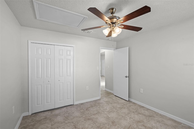 unfurnished bedroom featuring a textured ceiling, baseboards, visible vents, a ceiling fan, and a closet
