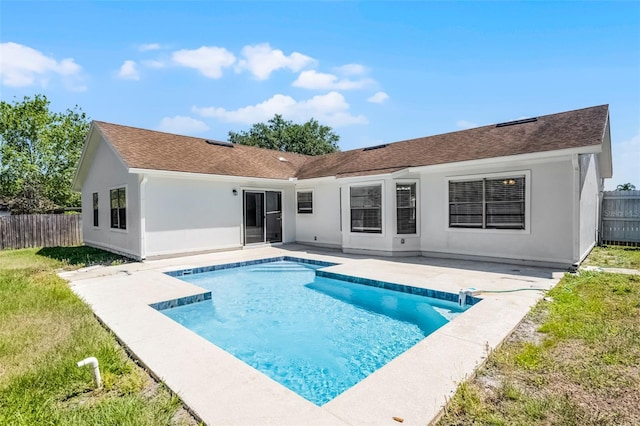 rear view of house with a fenced backyard, a patio area, a fenced in pool, and stucco siding