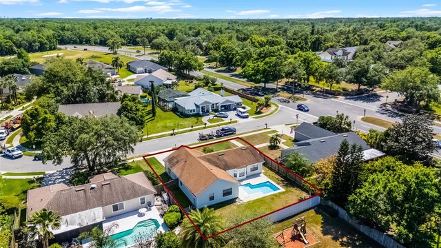bird's eye view featuring a view of trees and a residential view