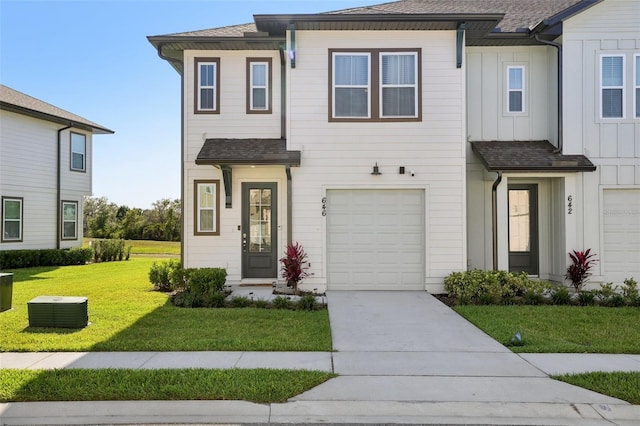 646 Longboat Dr, Davenport, FL 33896 - view of property with concrete driveway, board and batten siding, an attached garage, a front yard, and roof with shingles