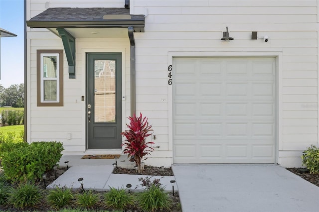 646 Longboat Dr, Davenport, FL 33896 - property entrance with concrete driveway and roof with shingles