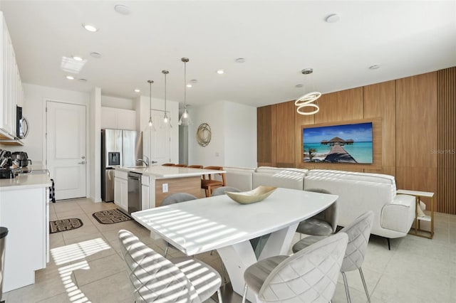646 Longboat Dr, Davenport, FL 33896 - dining room featuring wooden walls, recessed lighting, and light tile patterned flooring