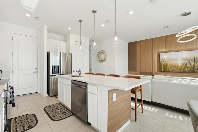 646 Longboat Dr, Davenport, FL 33896 - kitchen with stainless steel appliances, a breakfast bar, open floor plan, and light tile patterned floors