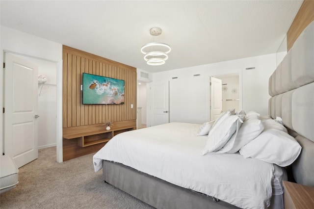 646 Longboat Dr, Davenport, FL 33896 - bedroom featuring wooden walls, visible vents, connected bathroom, baseboards, and light colored carpet