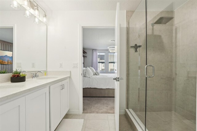 646 Longboat Dr, Davenport, FL 33896 - ensuite bathroom with tile patterned flooring, double vanity, a sink, tiled shower, and ensuite bathroom