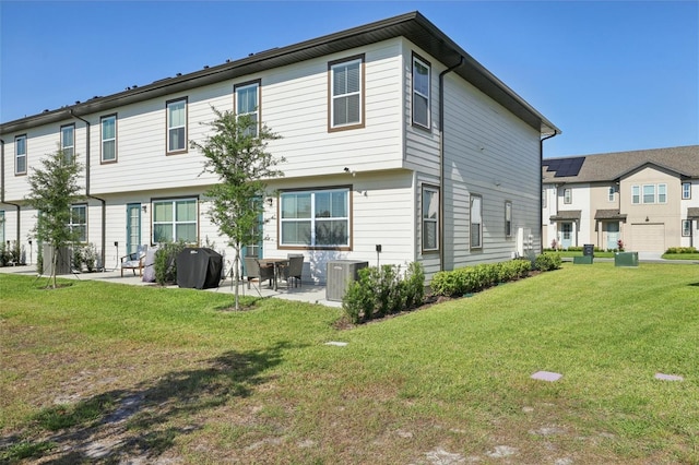646 Longboat Dr, Davenport, FL 33896 - rear view of house with a patio area, a yard, and central AC unit