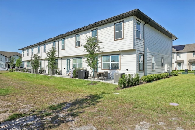 646 Longboat Dr, Davenport, FL 33896 - back of house with a lawn, central AC, and a patio