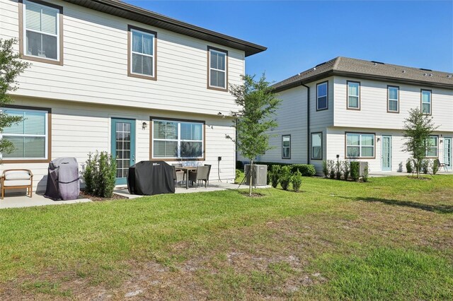 646 Longboat Dr, Davenport, FL 33896 - rear view of property with a yard, a patio area, and central AC unit