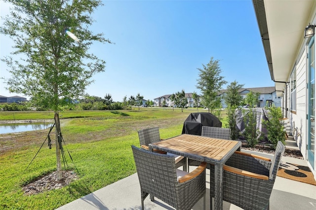 646 Longboat Dr, Davenport, FL 33896 - view of patio / terrace with outdoor dining area, a grill, and a water view