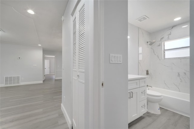 bathroom featuring visible vents, toilet, vanity, and bathing tub / shower combination