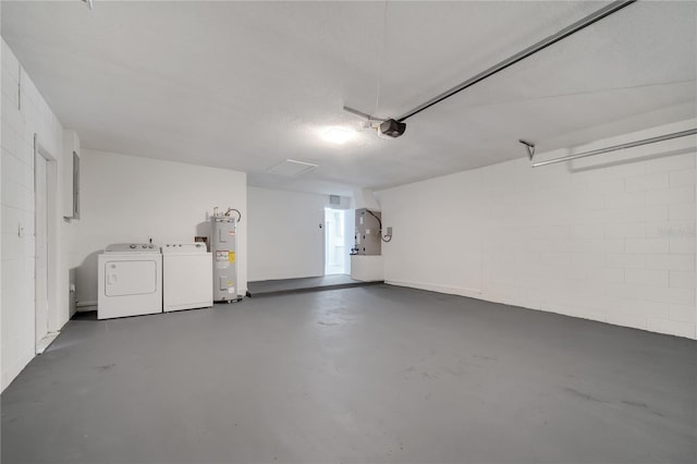 garage with washing machine and clothes dryer, concrete block wall, electric water heater, and a garage door opener