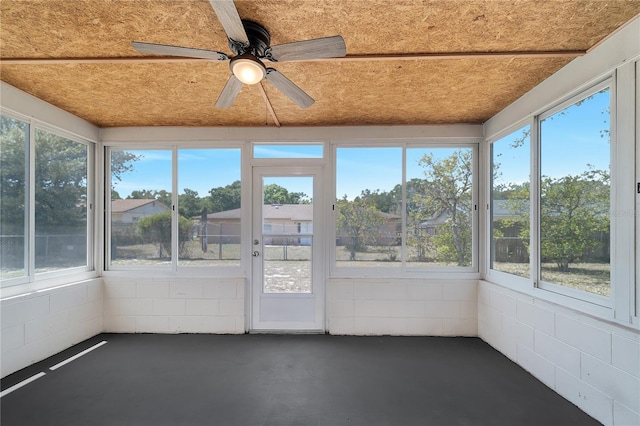 unfurnished sunroom with ceiling fan and a healthy amount of sunlight