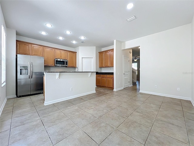 kitchen with recessed lighting, appliances with stainless steel finishes, visible vents, and light tile patterned floors