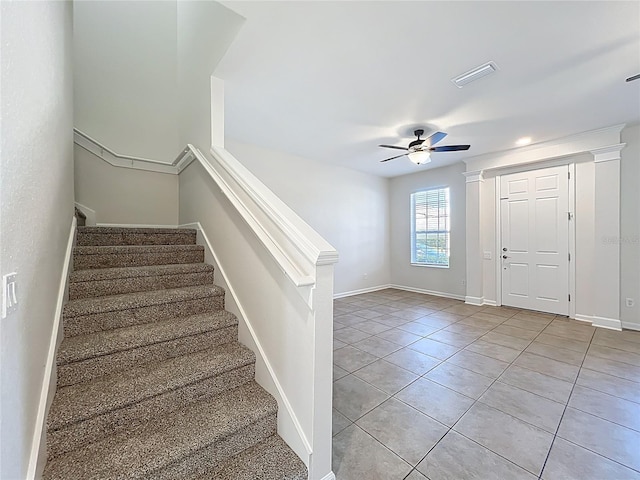 foyer with stairway, light tile patterned flooring, ceiling fan, baseboards, and visible vents