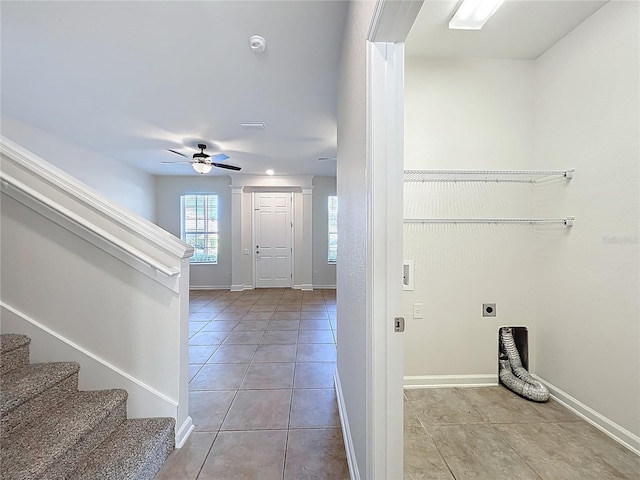 foyer featuring a ceiling fan, baseboards, stairs, and light tile patterned floors