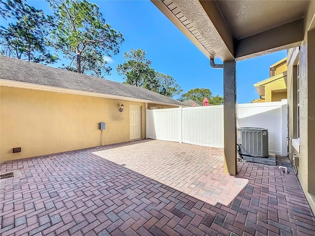 view of patio with fence and cooling unit